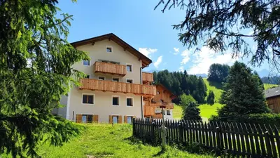 a house on a hill with a fence in front of it at Villa Erica in Badia