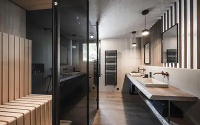 a bathroom with two sinks and two mirrors at Avita Loft by Avita suites to relax in Santa Cristina in Val Gardena