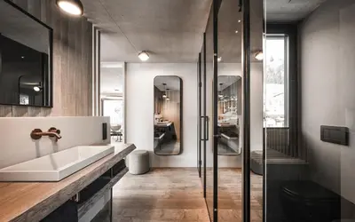 a bathroom with a sink and a glass shower at Avita Loft by Avita suites to relax in Santa Cristina in Val Gardena