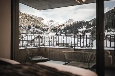 a view of a snowy mountain from a balcony at Avita Loft by Avita suites to relax in Santa Cristina in Val Gardena
