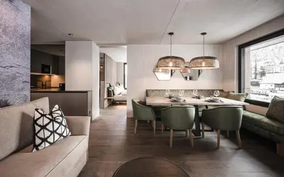 a kitchen and living room with a table and chairs at Avita Loft by Avita suites to relax in Santa Cristina in Val Gardena