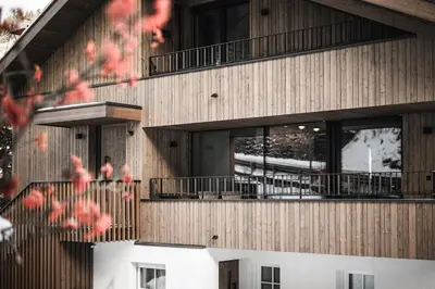 a building with balconies on the side of it at Avita Loft by Avita suites to relax in Santa Cristina in Val Gardena