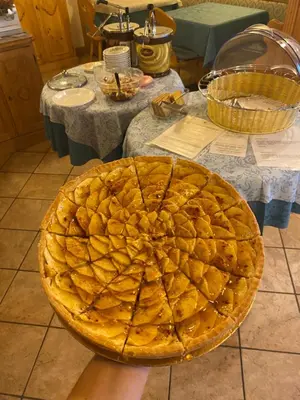 a pie sitting on top of a table with two tables at Garní Ladinia in Pescul