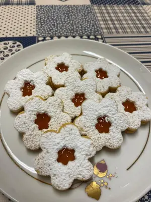 a plate of cookies with powdered sugar on it at Garní Ladinia in Pescul