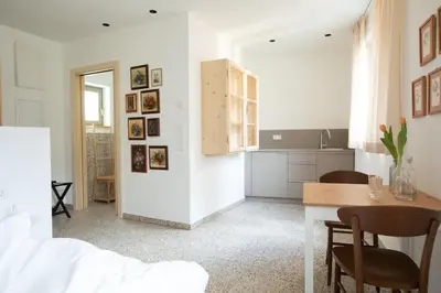 a kitchen and dining room with a table and chairs at DOMUS FABER in Merano