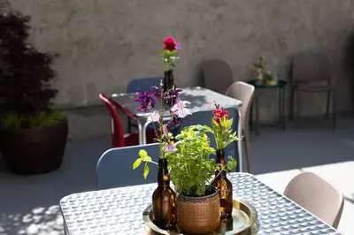 a table with two bottles and flowers on it at DOMUS FABER in Merano
