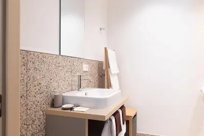 a bathroom with a sink and a mirror at DOMUS FABER in Merano