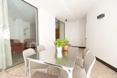 a dining room with a table and chairs at DOMUS FABER in Merano