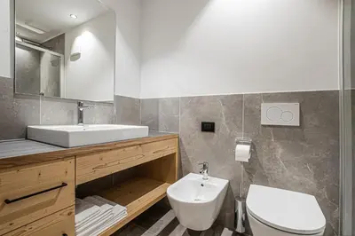 a bathroom with a sink and a toilet at Bio Lüch Ruances in San Cassiano