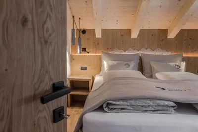 a kitchen with a sink and a couch in a room at Bio Lüch Ruances in San Cassiano