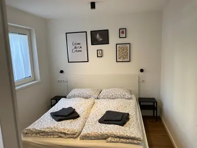 a bedroom with two beds and a window at M&M-Apartment in Brunico