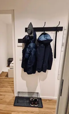 a room with two jackets hanging on a wall at M&M-Apartment in Brunico