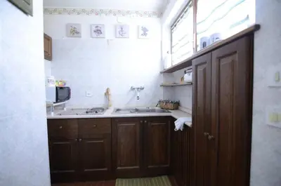 a small kitchen with a sink and a window at Cà Mughi Studio in Zuel