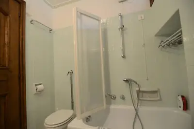 a bathroom with a shower and a toilet and a tub at Cà Mughi Studio in Zuel