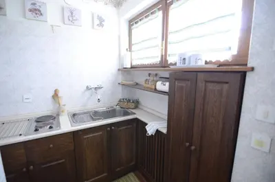a small kitchen with a sink and a window at Cà Mughi Studio in Zuel