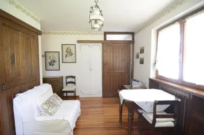 a living room with a white couch and a table at Cà Mughi Studio in Zuel