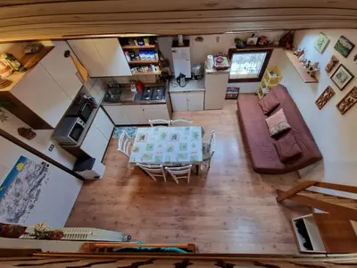 an overhead view of a living room and kitchen with a table at Appartamento Latemar Predazzo in Predazzo