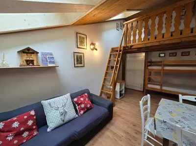 a living room with a couch and a bunk bed at Appartamento Latemar Predazzo in Predazzo