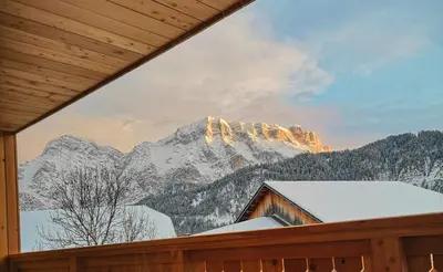 a living room with a table and a couch at Chalet Soredlin in La Valle
