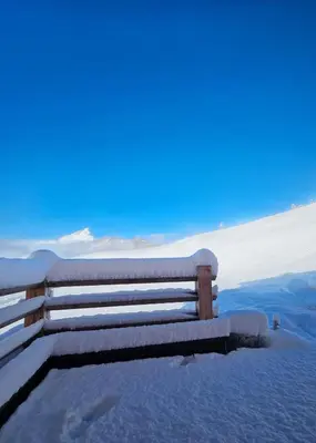 a bench covered in snow on top of a mountain at Chalet Soredlin in La Valle