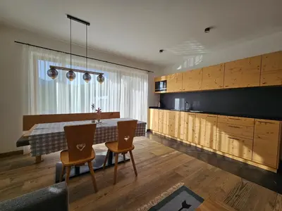 a kitchen with a table and chairs in a room at Chalet Soredlin in La Valle