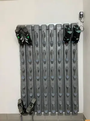 a metal radiator with four pairs of shoes on it at GSCNARA - APARTMENT LIN in Antermoia
