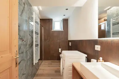 a bathroom with a sink and a toilet at Francesca's home in Pozza di Fassa