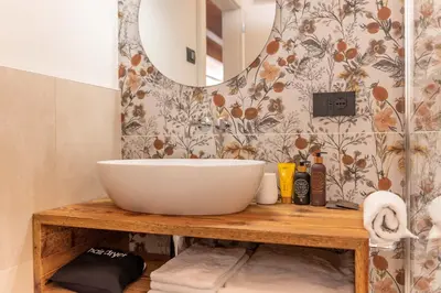 a bathroom with a bowl sink and a mirror at B&B El Lares - B&B L'Avez in Canale dʼAgordo
