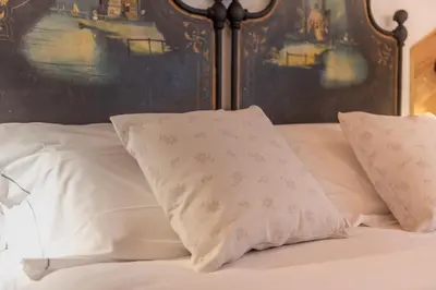 a bed with two pillows on top of it at B&B El Lares - B&B L'Avez in Canale dʼAgordo