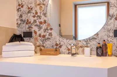 a bathroom with a sink and a mirror at B&B El Lares - B&B L'Avez in Canale dʼAgordo