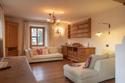 a living room with two couches and a table at Casa Da l Oio in Cortina dʼAmpezzo