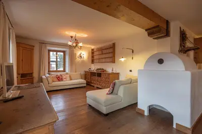 a living room with two couches and a table at Casa Da l Oio in Cortina dʼAmpezzo