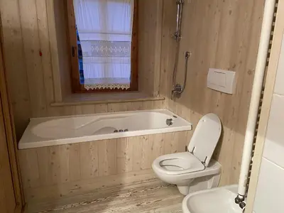 a bedroom with two bunk beds and a window at Casa Da l Oio in Cortina dʼAmpezzo