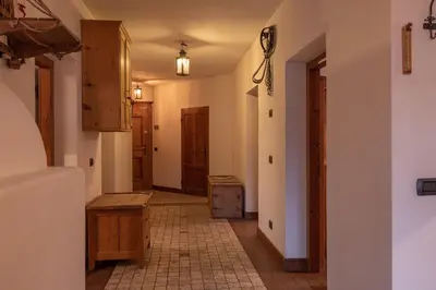 a bathroom with a tub and a toilet and a sink at Casa Da l Oio in Cortina dʼAmpezzo