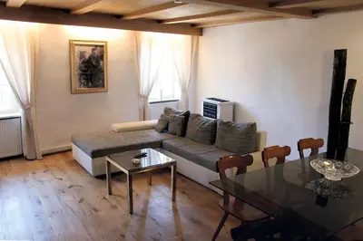 a living room with a couch and a table at Cirillo Guesthouse in Cortaccia