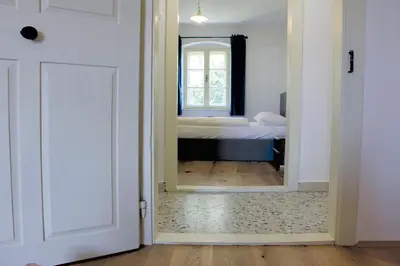 a door leading to a bedroom with a bed at Cirillo Guesthouse in Cortaccia