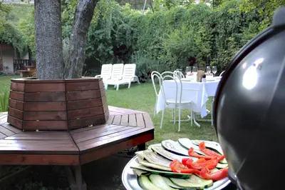 a table with plates of food and a table with a table with chairs at Cirillo Guesthouse in Cortaccia
