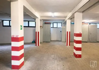 an empty room with red and white columns at Hometoday - Appartamento nel cuore di San Vito di Cadore in San Vito di Cadore