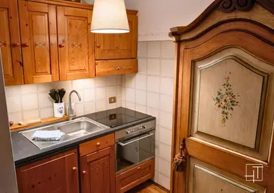 a kitchen with a sink and a stove at Hometoday - Appartamento nel cuore di San Vito di Cadore in San Vito di Cadore