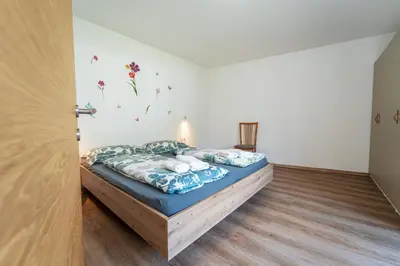a bedroom with a bed with a blue comforter at Mias Apartments in Rablà