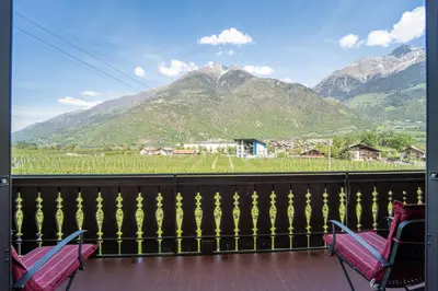 two chairs on a balcony with a view of a mountain at Mias Apartments in Rablà