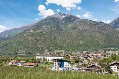 a village in front of a mountain at Mias Apartments in Rablà