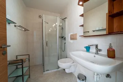 a bathroom with a toilet and a sink and a shower at Mias Apartments in Rablà