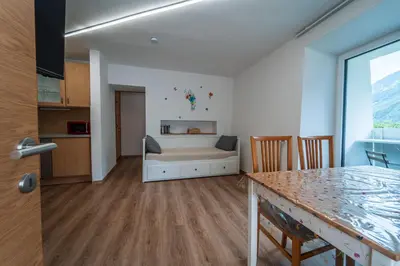 a living room with a couch and a table at Mias Apartments in Rablà