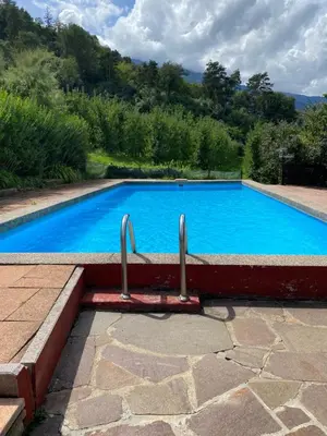 a large blue swimming pool in a yard at Mias Apartments in Rablà