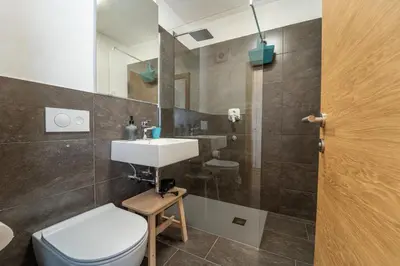 a bathroom with a sink and a toilet and a shower at Mias Apartments in Rablà