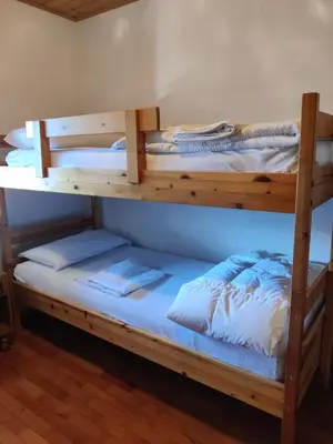 two bunk beds sitting on top of a room at Falcade Dolomiti La Quiete Mansarda panoramica in Fregona