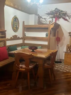 a dining room with a table and a bunk bed at Casa De Lotto in San Vito di Cadore