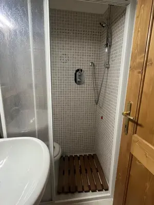 a bathroom with a shower with a sink and a toilet at Casa De Lotto in San Vito di Cadore