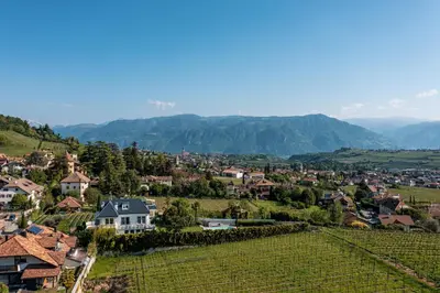a small town in a valley with mountains at Mias Apartments - #MiasEppan#Badl in Appiano sulla Strada del Vino